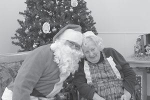 There were lots of Christmas events at the North Shore Care Center. Above: Christmas Eve at North Shore Care Center was hosted by Santa (Darrell Smith) and Mrs. Claus (Donna Willett). Upper right: Tina Kraus accompanied Mary and Doug Sanders for a holiday sing-a-long. Right: The Vineyard Church Carolers entertained residents. (L-R) Jane Howard, Georgene Daubanton and Melissa Breitsprecher on guitar.