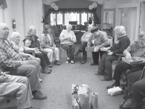 Above: On Dec. 20, the Senior Center enjoyed the Christmas Gift Exchange Game: (L-R) Tom Hedstrom, Gladys Anderson, Robin Derscheid, Renette Pearse, Betty Larsen, Betty Wilson, Esther Sorlie, Shirley Ellquist and Nona Smith. Participants rolled the dice for doubles until everyone had a gift. Gifts were then unwrapped and everyone proceeded to roll doubles and swap gifts. A couple of the most popular gifts were a bottle of peach schnapps and a towel set. Left: Another fun birthday celebration! On December 7, the Cook County Senior Center celebrated Gladys Anderson’s birthday. (L-R, seated) Renette Pearse, Gladys Anderson and Linda Johnson (from the back). Standing behind the birthday girl is Warren Anderson.