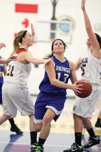 Above: Driving hard to the basket, Breana Peterson knifed between two defenders to score two points. Breanna scored 15 points in an overtime loss to Virginia at the Vikings’ holiday tournament. Right: On offense Leah Utities doesn’t shoot much, but she does a lot of the play making for the Vikings. On defense Leah is a dogged defender. Far right: Only a ninth-grader, Lily Gruber-Schulz is in her second year of playing for the varsity. Lily leads he Viking in rebounding and often is one of the t ams high est scorers.