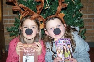 Two of Santa’s reindeer from the Birch Grove Community School winter musical with the books they received from the North Shore Federal Credit Union. Each year the NSFCU gives one book to each student at Birch Grove. The books are chosen by the student from the annual Scholastic Holiday Book Fair, a greatly anticipated event. The students performed The Littlest Reindeer in the afternoon and evening on December 18 and did a fantastic job! Each student took home their NSFCU book before leaving on break. Birch Grove Director Diane Blanchette said, “Thank you NSFCU for the great holiday gift!”