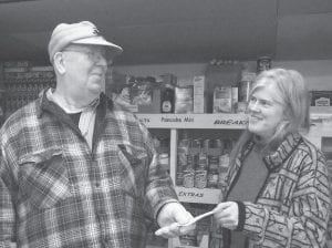 Tom Hedstrom was all over town on Monday, Jan. 7, delivering donations from the Eastern Star Emera Chapter to the Salvation Army, the Cook County Food Shelf and the North Shore Care Center activities fund. He is pictured here presenting a check to Kristine Bottorff of the Cook County Food Shelf. Although the Emera Chapter is located in Two Harbors, they continue to support the many Eastern Star members in Cook County.