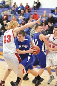 Left: As Jonny Jacobsen, No. 40, set a pick, Colin Everson ducked down and stepped around Moose Lake’s 6’5” center and scored a layup. Despite what looked to be an off night shooting the ball, Everson still managed 20 points to lead the team in scoring. Above: Peter Warren went up high to shoot and score 2 points over the outstretched arms of his Moose Lake defender.