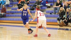 Above: Just an 8th grader, Essence Haines, No. 34, has come on strong for the Vikings, giving her teammates valuable minutes off the bench. Essence is both a good shooter and tough defender. Right: Breanna Peterson used her speed and superb ball-handling abilities to blow by the defender and set up a beautiful pass to Kaitlynn Linnell underneath the basket. Linnell scored an easy basket on the play. Peterson led her teammates in scoring against the Ely Timberwolves with 15 points.