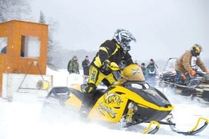 The Cook County RidgeRiders Snowmobile Club held its first snowmobile drag races of the season on Saturday, January 19. A hardy crowd turned out on Devil Track Lake to watch the action. Although about 6 inches of snow fell in the two days before the drag races, conditions were not ideal for drag racing. But these racers came out to fill their need for speed anyway. It was a beautiful day on the ice.