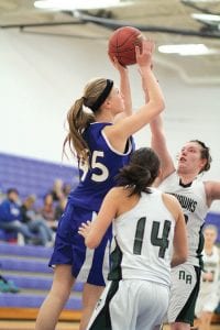 Left: Lily Gruber-Schulz (45) jumped high above the Northeast Range Nighthawk defenders to score two points. Two games later Gruber-Schulz hurt her ankle in the game against Silver Bay and is, sadly, out for the season. Above left: Kaylee Cronberg jukes the defender as she makes her way to the basket. Cronberg passed off on this play. Above right: Coming on strong for the Vikings is Liz O’Phelan who shoots but narrowly misses on this shot against the Nighthawks.