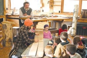 North House Folk School was alive with history and busy fourth graders as Mark Hansen (standing) and Ian Andrus (seated with toboggan) taught the kids how to make toboggans with the traditional techniques used by Ojibwa and early settlers. Hansen, one of the founders of North House, also taught the kids a good deal of local history during the three-day class.