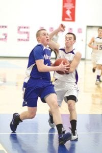 Above: Breaking hard for the basket, Lars Scannell drove around the Floodwood defender to score his only two points of the game. Just a sophomore, Scannell has emerged as one of the Vikings' key players as they get ready to head into the playoffs. Right: Senior guard Kale Boomer broke through the tight web of Floodwood’s defense to score an easy two points on this play. Boomer led all Viking scorers with 17 points and nearly brought his team all the way back in a hard fought, defensive battle against a very good Floodwood team.