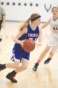 Above: Suzy Burton is a new starter for the Vikings, but has been more then capable on the floor. Against Marshall Burton scored 8 points and played very good on defense. Upper right: No. 21 Jamie Sjogren had to fight hard to get a shot off through a sea of hands in the game against Floodwood while No. 15 Kaitlynn Linnell got ready to pick up the rebound. Right: Trace McQuatters (with the ball) passed it to an open Viking player who scored a lay-up while Breana Peterson set a pick to free up the lane.