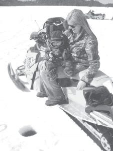 There are many ways to enjoy ice fishing, but none better than fishing with your children as demonstrated by this mother and her child. Lots of moms and dads and children will be fishing for prizes and fun on March 3 on Gunflint Lake during the annual trout derby sponsored by the Cook County Snowmobile Club.