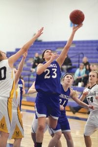 With Jamie Sjogren peeking underneath, Theresa Morrin went up for a layup against Wrenshall. Morrin led all Viking scorers with 18 points in the win against the Wrenshall Wrens.