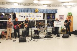 Portage shares its classic country with residents, families and friends at the North Shore Care Center on the last Saturday of each month. On Saturday, February 23, the dance included congratulations to the band on receiving the 2013 Volunteer of the Year award from the Aging Services of Minnesota. Activities Director Kay Rosenthal applauds the band, whose members are (L-R) Butch Deschampe, Tom Hoy, Joe Peterson, Jimmy Spry and Arvid Dahl.