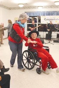 Left: Eleanor Matsis gives Portage a thumbs up as she moves on the dance floor with volunteer, Patty Martin. Above: Marge Jamison and her daughter, Diana Schultz, cheer on their favorite band, Portage.