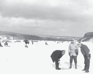 Another historic ice fishing adventure, courtesy of the Howard Joynes collection. This photo, taken by M.J. Humphrey, shows some hopeful anglers watching a fishing hole. Only one person is identified, Glen Bergstrom, on the right. Do you know the others?