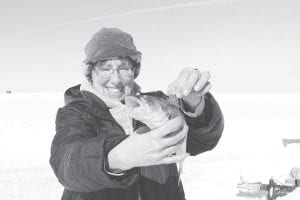 News-Herald Editor Rhonda Silence had success on an ice fishing weekend in Baudette, Minnesota. She caught a few fish, including this 13-inch sauger, a delicious cousin to the walleye. Rhonda checks out the black spots on the top fin, which identifies the fish as a sauger.