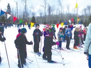 The Cook County Y-ski program held its season grand finale—the Y-ski Olympics—on Saturday, February 23 at the Pincushion Mountain Ski Trails. There was a great turnout with many of the 60 kids who had participated in the Y-ski program coming out to enjoy the Y-ski Olympics. Above left: They excitedly lined up for the end of the day race and other events such as a bobsled run, a slalom course, chariot races and an obstacle course. Above right: Gus and Flinn relaxing between events. Below right: Sophia and Aurora join forces for a tandem slalom run.