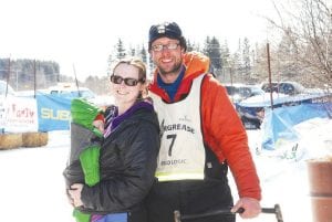 Odin Jorgenson of Grand Marais crossed the 2013 John Beargrease Sled Dog Marathon finish line in third place, the best finish he has had in the approximately 400-mile marathon. Waiting at the finish line was his wife, Betsy and baby boy, Gunnar.