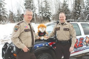 Outgoing D.A.R.E. officer, Chief Deputy Leif Lunde (left) “passes the torch” to new D.A.R.E. officer, Deputy Ben Hallberg. Since there is no actual torch to pass, Darin the D.A.R.E. lion had to do. Deputy Hallberg has already begun visiting area schools to share the program’s drug and alcohol resistance message.