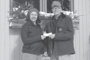 Mike Carlson receives the first Residential Energy Efficiency Project (REEP) rebate check from Cook County Local Energy Project (CCLEP) Coordinator Virginia Danfelt. The Carlsons are the first homeowners to complete improvements and qualify for an audit rebate that is part of the REEP pilot project. The program kicked off last fall and is still in progress. To learn more see the CCLEP web site (www.cookcountylep.org) or e-mail Danfelt at localenergy@boreal.org.