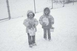 The Easter Egg Hunt at the Cook County Community Center takes place no matter what the weather is like. These little girls, at a previous event, didn’t mind the snow at all!