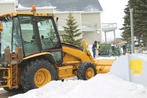 Grand Marais Public Utility workers had a backhoe standing by to unearth a broken power line on Tuesday, March 19. The excavation will wait until spring though, as the electrical lines were temporarily rerouted to get the power back on.