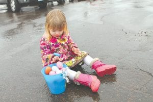 As it has for just about every year that the Cook County KidsPlus Easter Egg Hunt has been held, it rained on Saturday, March 30, 2013. And as always, there was a fantastic turnout for the event anyway. No one minded hunting colorful eggs in the rain, especially this little girl who just wanted to see what was inside! See more Easter Egg Hunt fun on page A3.