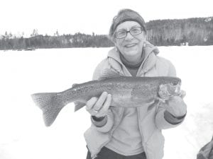 Above: Diane Wimmer shows off the beautiful rainbow trout she caught on March 5. The 21½-inch rainbow put her in the lead in the Trail Center Fishing Contest for rainbow trout. Diane said it made a delicious dinner.