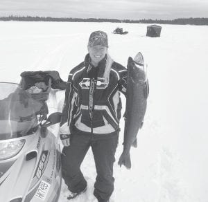 Left: This 35-inch lake trout earned Julie Collman of Grand Marais first place in the Trail Center Fishing Contest. Julie caught the trout on the Canadian side of Saganaga Lake. Julie said, “It was an old fish, as the dorsal fin and the lower tail fin were almost gone.” She added, “It was really fun to catch!”