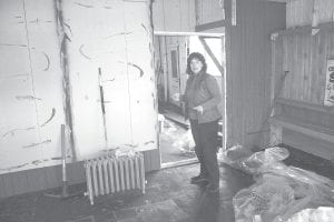 Julie Carlson of Joynes Ben Franklin does a final walk-through of the old building that has been used for many years as storage for the department store. Carlson would like to collect memories from people who remember visiting the old building, which was built by John Johnson in the fall of 1908. The building once stood where the Joynes Ben Franklin is today and was first known as Johnson’s New Place. Little is known about the building from 1909 to 1944, but Gene Glader, in his book Downtown Grand Marais, wrote about the building as home to the Soderberg Dry Goods & Clothing Store in 1933, as well as the Bay View or Shore View Hotel upstairs. The building served as home to several other businesses—the Photo Art Shop and Humphrey’s Clothing— before it was purchased by Howard Joynes and moved to its present location in 1951. The building is being demolished by Edwin E. Thoreson, Inc. Carlson said no decision has been made yet on the future of the lot.