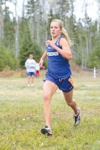 Sarissa Falk is shown here running in a high school cross country race held at Pincushion Mountain last fall. Falk, an outstanding long distance runner, has been invited to compete in the Down Under Sports tournament to be held in Australia this summer. She is one of six high school runners from Minnesota invited to the competition.