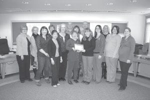 A contingent of Cook County professionals who provide services to children and families attended the county board meeting on April 23, 2013 to celebrate a Blue Ribbon Award from Prevent Child Abuse Minnesota, a chapter of Prevent Child Abuse America, whose mission is to empower individuals and communities to stop child abuse and neglect before it starts through education, advocacy, and family support. According to Cook County Public Health & Human Services (PHHS) Case Aide Anna Sandstrom, who prepared the application for the award, “Cook County’s child abuse prevention efforts involve a strong network of professionals collaborating on a monthly basis to strengthen families and reduce barriers to resources and services. …Together, we are working on positive parenting, early intervention, support to parents, and overall reducing barriers to strengthen families and our community.” Cook County Public Health & Human Services Director Sue Futterer thanked the county board and the Grand Portage Tribal Council for the support and funding they provide. (L-R) Jodi Yuhasey (Violence Prevention Center), Heidi Doo-Kirk (county commissioner), Lucy Perpich (Violence Prevention Center), Sue Hakes (county commissioner), Jeanne Smith (County Attorney’s Office), Beth Faraone (PHHS), Bruce Martinson (county commissioner), Jodi Kristenson (PHHS), Grace Bouchard (PHHS), Garry Gamble (county commissioner), Patty Foley (Grand Portage Human Services), Anna Sandstrom (PHHS), Sue Futterer (PHHS), Molly Hicken (County Attorney’s Office), and Alison McIntyre (PHHS).