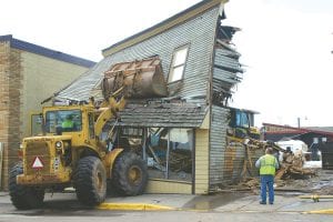 The demolition of the Joynes Ben Franklin storage building on First Avenue, the former home to a number of Grand Marais businesses, is complete. Just moments after this photo was taken April 23, there was nothing left but a pile of old lumber. Workers with Edwin E. Thoreson, Inc. are conducting the final cleanup, but the building that served as home to the Bay View and Shore View hotels, the Photo Art Shop and Humphrey’s Clothing is gone.