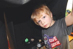 The Science Fair at Great Expectations School on Thursday, April 25 had 36 displays. Eli’s was one of the most popular, with people popping their head inside a black box to see how crystals react to light.