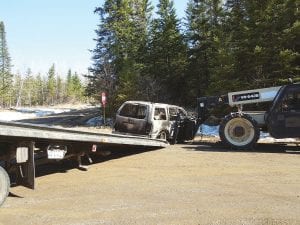 This Ford Explorer caught fire while Anita Frank was driving to her Jackson Lake home on Sunday, May 5, 2013. The Hovland Fire Department responded, but the vehicle was a total loss by the time they had been notified and were able to respond. Because of road conditions, a tow truck was not able to get to the car so contractor Doug Seim transported the car out with a forklift to the Arrowhead Trail to be picked up by Wally’s Towing.