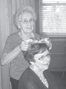 The Bethlehem Lutheran Church Women held their annual spring luncheon on Saturday, May 11. The church fellowship hall was decorated beautifully in keeping with this year’s theme, “Spring into Life.” A member of the decorating committee—Martha Rosbacka—received special recognition as the 2013 Bethlehem Lutheran “Angel of the Year.” Gladys Dockan, a former “Angel,” passes the angel crown to Rosbacka, who was honored for all the work she has done for the church and the community.