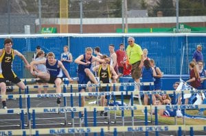 Above: Senior hurdler Kyle Martinson shows his form at the Eveleth Golden Bear Invitational meet held last week in Virginia. Martinson placed in the top half of the field in the high hurdles race and ran 27 seconds flat in the 200 meters. Left: Meadow Adams (near) and Mara MacDonell (far left) ran 55.5 seconds and 61.3 seconds in the 300-meter low hurdle race. Adams also ran a 6:56 mile and MacDonell placed 9th in the triple jump with a hop, step and a jump totaling 25 feet 5 inches.