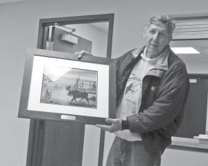 At the Lutsen Town Meeting on Tuesday, May 21, the Deer Yard Lake Association gave a lovely work of art to hang in the town hall. Above: Jeff Latz of the lake association presents a beautiful print by the late Kara Pavelich. Left: Already in place is a beautiful quilt made by Anna Latz. There will be a rotating display of quilts at the township to enjoy.