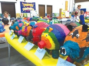 One of the cutest displays was the table full of papier-mâché piggy banks made by the first-grade class. Each pig was blessed with a lot of colorful personality.