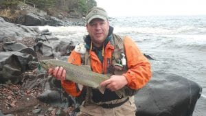 Paul Davis of Mankato with the steelhead he caught and released at the mouth of the Cascade River Saturday, May 18, 2013. He and his friend Scott MacLean were visiting Scott’s parents, David and Bonnie MacLean of Grand Marais.