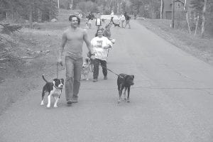 Seventeen dogs brought their owners to dog behaviorist Jeff Morgan (in front) on Tuesday, May 28 so their owners could receive instruction on how to train them. Morgan spent three hours with the owners and their dogs and worked on socialization between a variety of dogs and people. Morgan, originally from Israel and now residing in Connecticut, came at the request of Delayne Duhaime of Grand Portage (pictured behind Morgan) who is interested in starting a career as a dog behaviorist. The class was held at the Cook County Community Center and was, according to several dogs interviewed, a howling success.