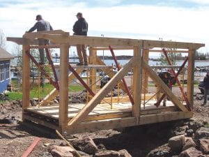 Cook County and Silver Bay high school students have been taking timber framing classes at North House Folk School for several years. Recently a small group of students erected this timber frame brige, which will be part of the Grand Marais Recreation Park’s Community Connection. The new walkway is almost complete and will be accessible in time for the 2013 Wooden Boat Show at North House Folk School.