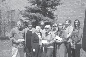 Not all of the recipients of Arrowhead Electric Cooperative's (AECI) Operation Round Up awards were on hand Saturday, June 8 to receive their grants, but those who were happily accepted for their organizations. (L-R) John Schloot, Sue Hakes, Mary Sanders, Karl Hansen, Barb Gervais, Suzan From, Nicky Boostrom, Jennifer Spearing and AECI presenter of awards, Jenny Kartes.