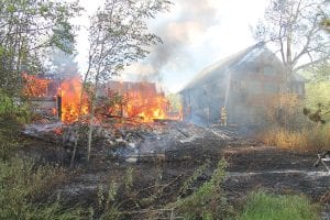 The house at 223 Fireweed Lane on Devil Track was an inferno by the time firefighters and equipment from six different fire departments arrived and set up water drop tanks and hoses. Firefighters frantically worked to save the house at 225 Fireweed Lane. The fire was extinguished after five hours, however it is likely that the building is a total loss.