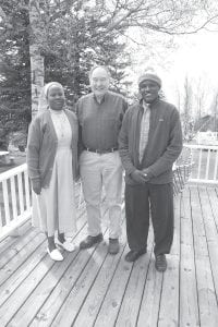 Gordon Lindquist of Grand Marais hosted two Ugandans on a trip to Minnesota in May to raise awareness of needs at a health clinic in southwestern Uganda. He is helping them raise funds for a surgical facility that is expected to save many lives. Father Dennis wore a green stocking cap of Gordon’s for most of the visit because the May weather in Minnesota was much colder than what they are used to near the equator in Uganda. (L-R) Sister Christine Nakanwag, Gordon Lindquist, and Father Dennis Abagaba.