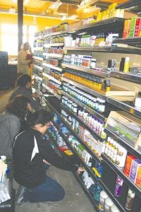 A team of volunteers and co-op employees worked diligently last week to set items on shelves as the impending opening date for the new store of June 26 quickly approaches. The new store is located in the same location as the old store next to Stone Harbor and will offer more items and a deli that seats 34 people.