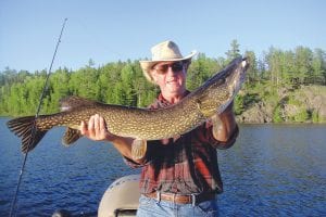 Sagonto Resort on Lake Saganaga had some very successful anglers on June 14 -15. Dr. Kirk Clark and his wife Holly from Columbus, Indiana came to Sag for bass fishing, but had better luck with other species. Left: On Friday, Holly Clark was very surprised to catch a 24-inch lake trout while casting a top water lure for bass. Guide Marco Manzo III said the trout was an exceptional specimen without a mar on the skin. Above: On Saturday, Kirk Clark caught and released a 40-inch northern. Kirk was also using a top water lure, casting for small mouth bass.