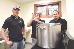 Firefighter James Coleman, Lutsen Fire Chief Paul Goettl, and Firefighter Steve Duclos stirred the giant pot of chili served to visitors. The spicy fire hall chili turned out quite hot and liberal amounts of sour cream and crackers were consumed.