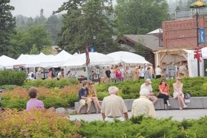 The Grand Marais Arts Festival brings hundreds of people to downtown Grand Marais to explore the offerings of 70 artists. Left: Festival visitors can make a special Arts Festival T-shirt. Above: Mary MacDonald will be back this year with her loom.