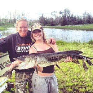 Above: Not your ordinary day of fishing! Julie Collman, her daughter Jessica and Mark Welinski of Duluth were fishing on Lake Saganaga on June 28 when they came upon this huge 37-inch-plus northern pike floating— with a red sucker stuck in its mouth. Julie noted, “The pike literally bit off more than it could chew.”