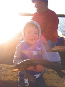 Left: Mason Gervais was all smiles on his first fishing trip with his dad, Todd Gervais, and grandpa, Ron Gervais (behind Mason).