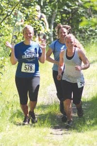 Left: Their smiles say it all, Laurie Senty (in front) and her two daughters Kelly (left) and Hanna ran a leisurely pace at the Tofte Trek and had a great time doing the race together. Above: No one runs harder or with more joy than children as evidenced here in this picture. These kids took part in one of the many children’s races held at the Tofte Trek.